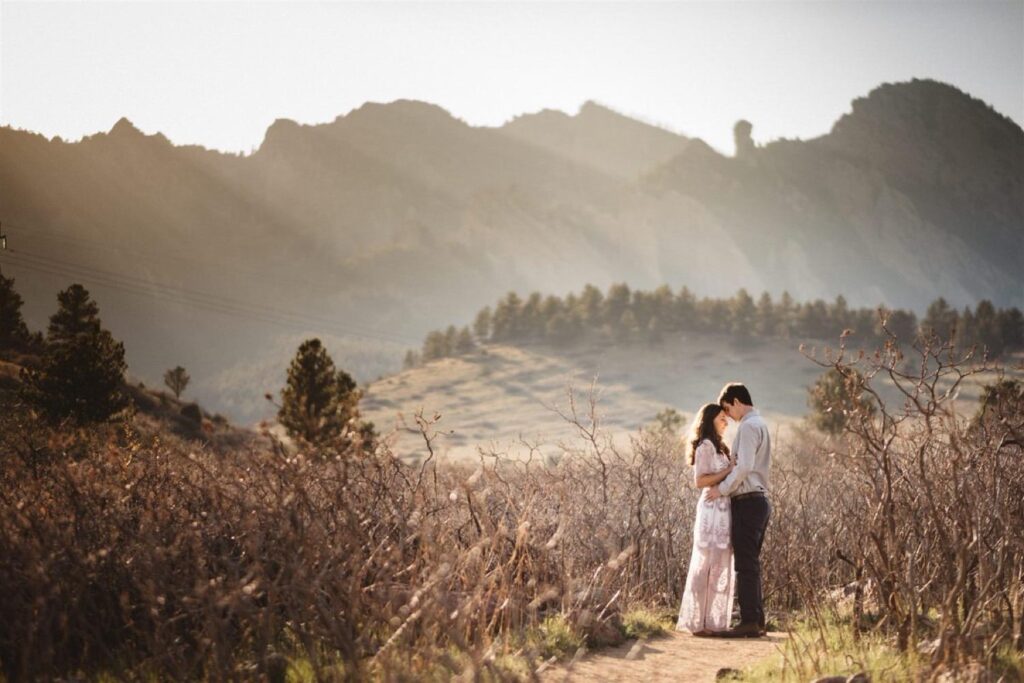 Couple posing for engagement photos at south mesa trailhead in boulder colorado. Jpg