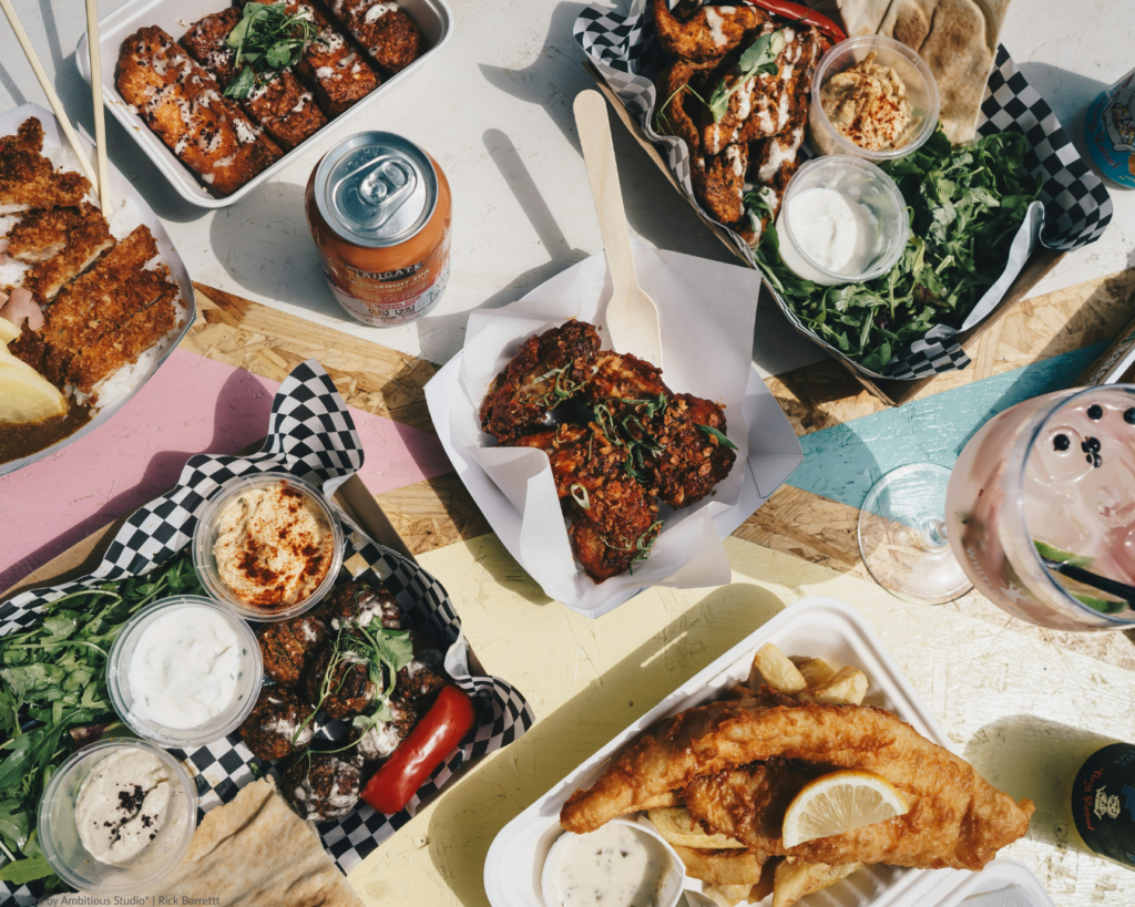 The &Quot;Mud Season&Quot; Manifesto: Why Spring Is Colorado’s Best-Kept Secret 5 Outdoor dining spread with craft beer and local food at a denver colorado food hall.
