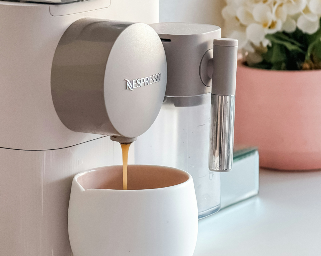 Minimalist kitchen counter with an espresso machine and fresh greenery