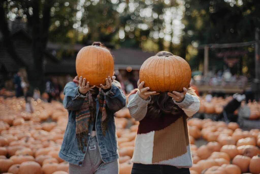Friends picking pumpkins at a colorado pumpkin patch this fall - things to do in colorado this fall