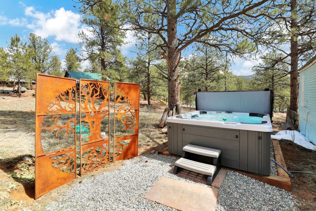 Hot tub at timeless pineview cottage, a pet-friendly cabin near denver in pine, colorado
